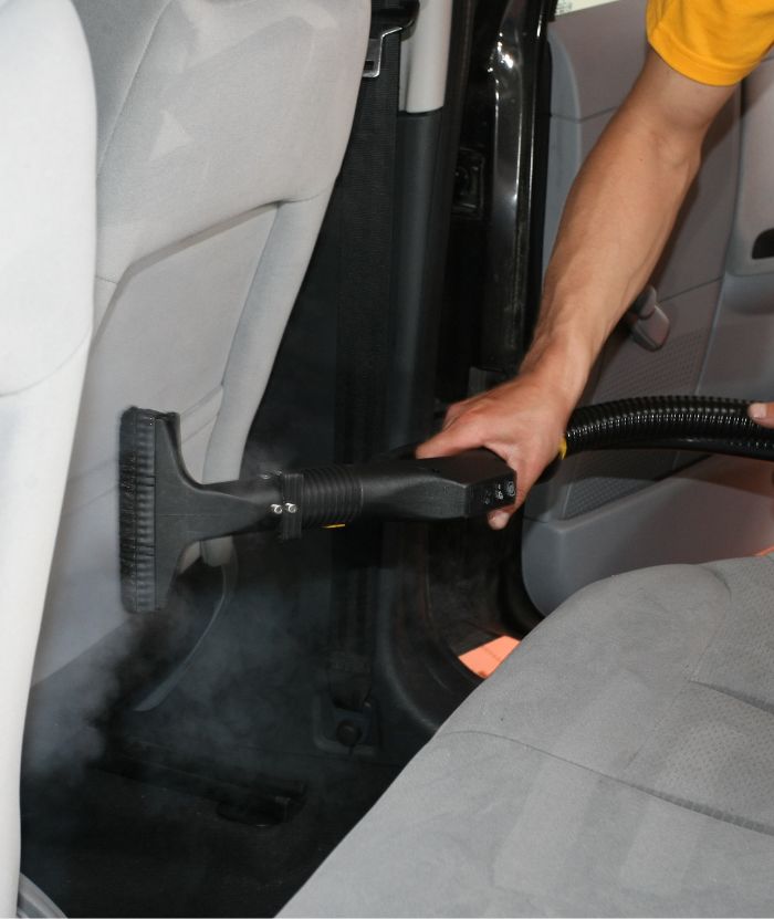 Cleaning car seats with steamer and carpet extractor